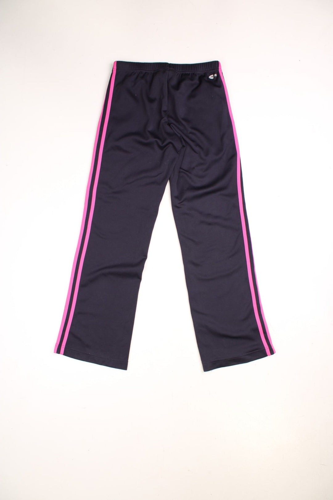  Tracksuit Bottoms in a navy  and pink colourway with the iconic three stripes going down the legs, has side pockets, an adjustable waist with drawstring and the logo embroidered on the front.