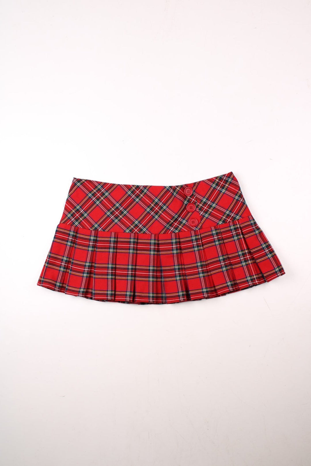 Y2K pleated plaid mini skirt in red with buttons on the front and zip closure in the back by Internacionale.