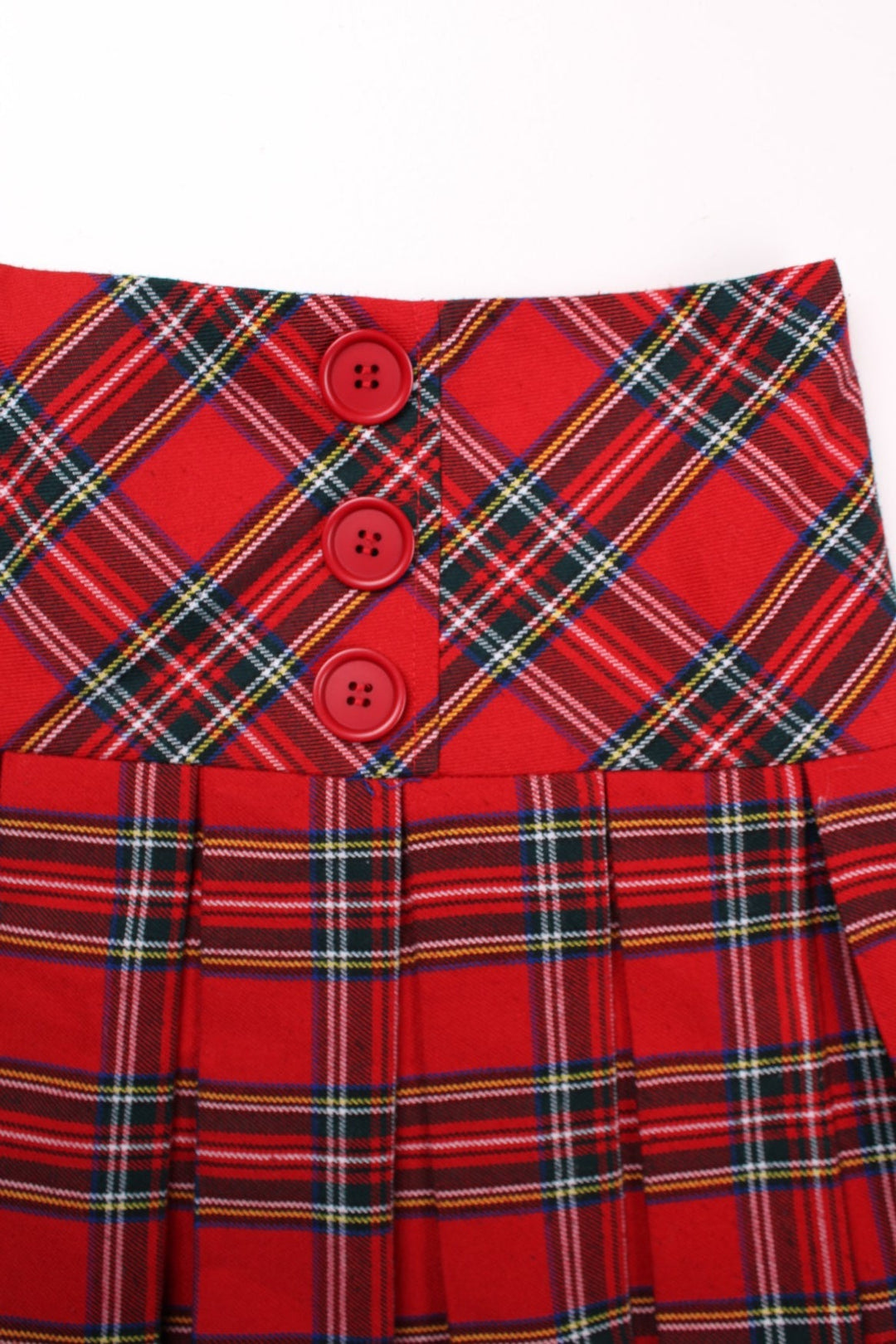 Y2K pleated plaid mini skirt in red with buttons on the front and zip closure in the back by Internacionale.