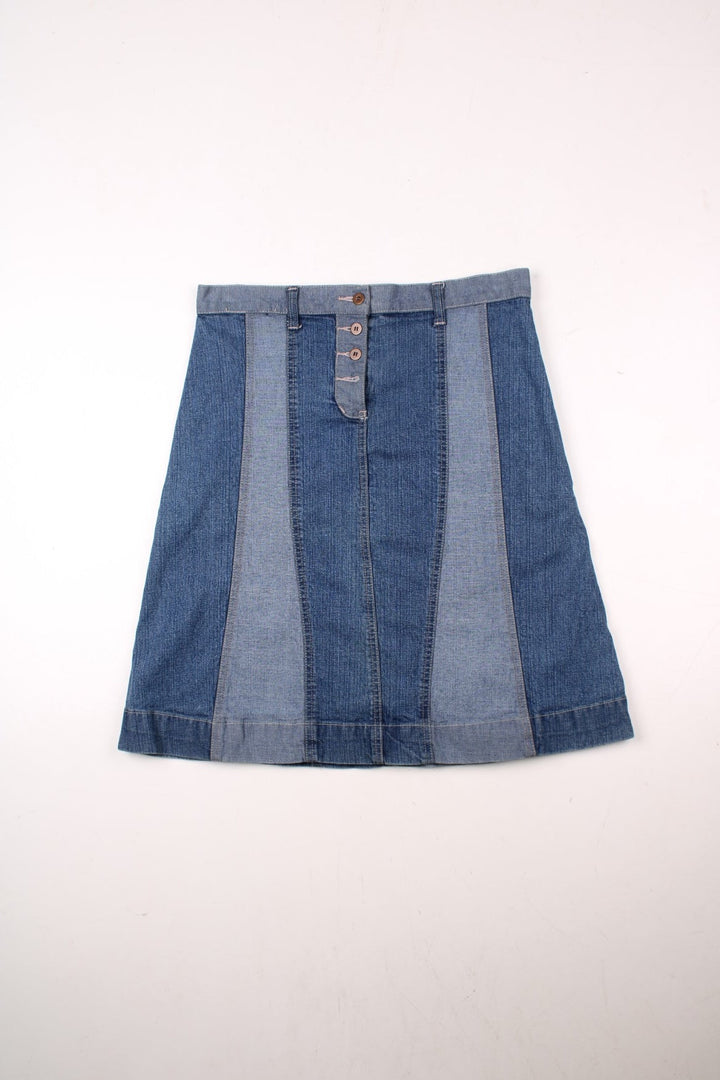 Y2K A-line denim midi skirt in panels of light and dark blue with belt loops, two back pockets, and button closure by Golding.