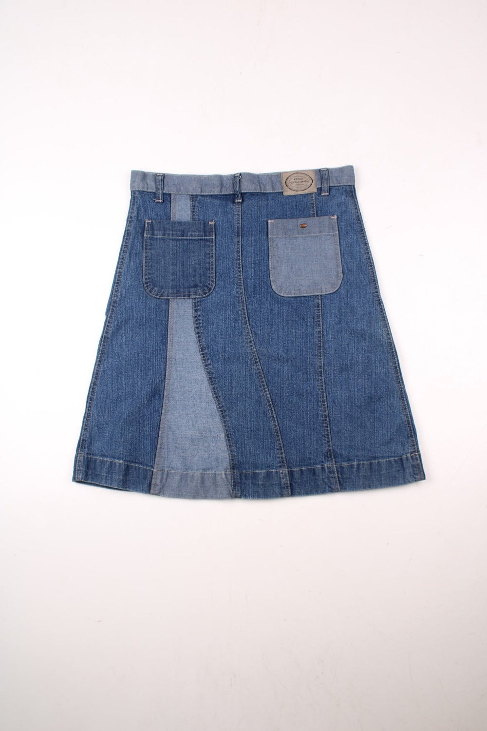 Y2K A-line denim midi skirt in panels of light and dark blue with belt loops, two back pockets, and button closure by Golding.