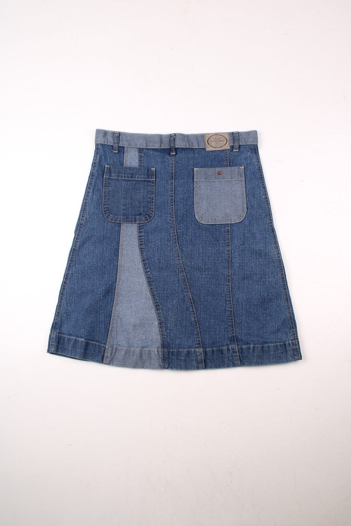 Y2K A-line denim midi skirt in panels of light and dark blue with belt loops, two back pockets, and button closure by Golding.