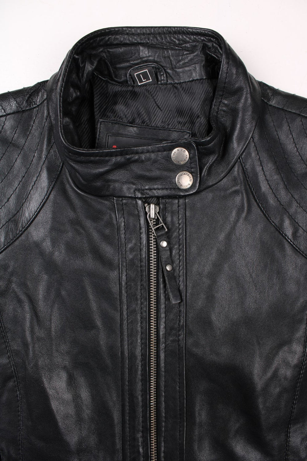 Y2K Aviatrix jacket in black real leather with two pockets, zip and snap closure, and branded hardware.