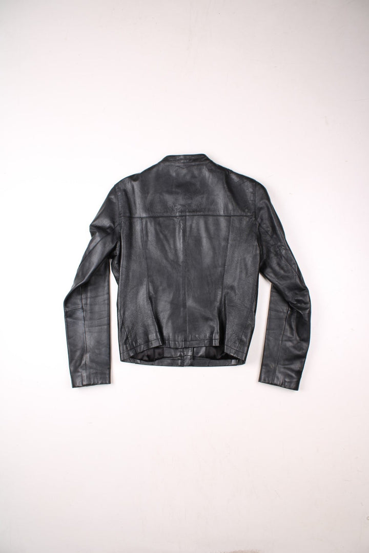 Y2K Bay collarless real leather jacket in black with two pockets and zip and snap closure.