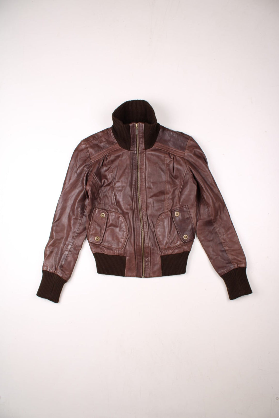 Y2K Oasis real leather jacket in brown with zip closure, two snapped pockets, and a ribbed collar, cuffs, and hem.