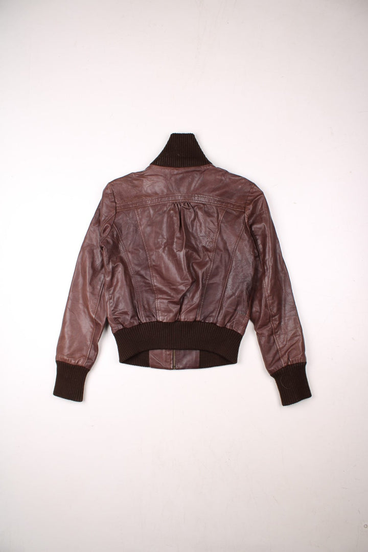 Y2K Oasis real leather jacket in brown with zip closure, two snapped pockets, and a ribbed collar, cuffs, and hem.