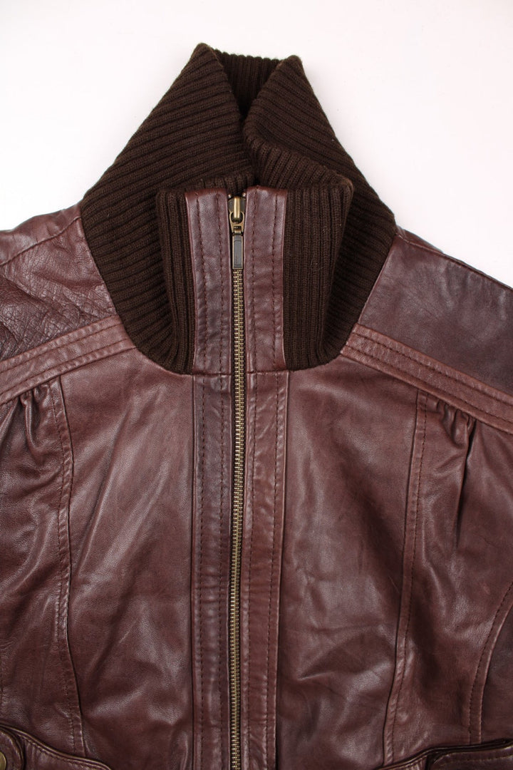 Y2K Oasis real leather jacket in brown with zip closure, two snapped pockets, and a ribbed collar, cuffs, and hem.