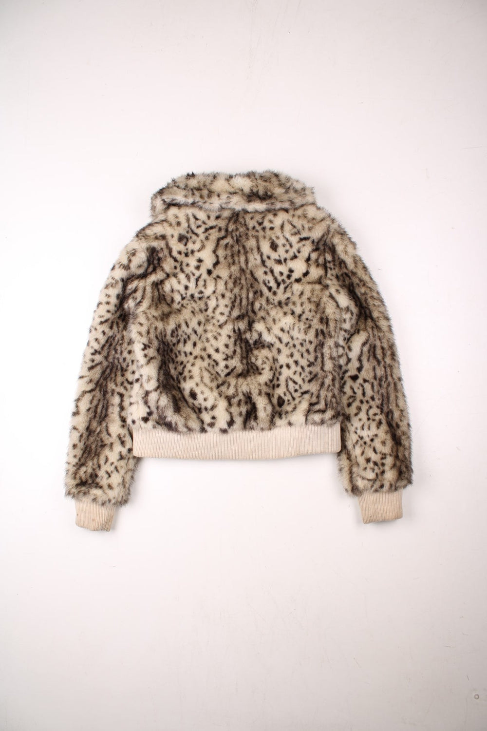 Y2K faux fur cropped jacket in tan with ribbed cuffs and hem, two pockets and zip closure by Honee.