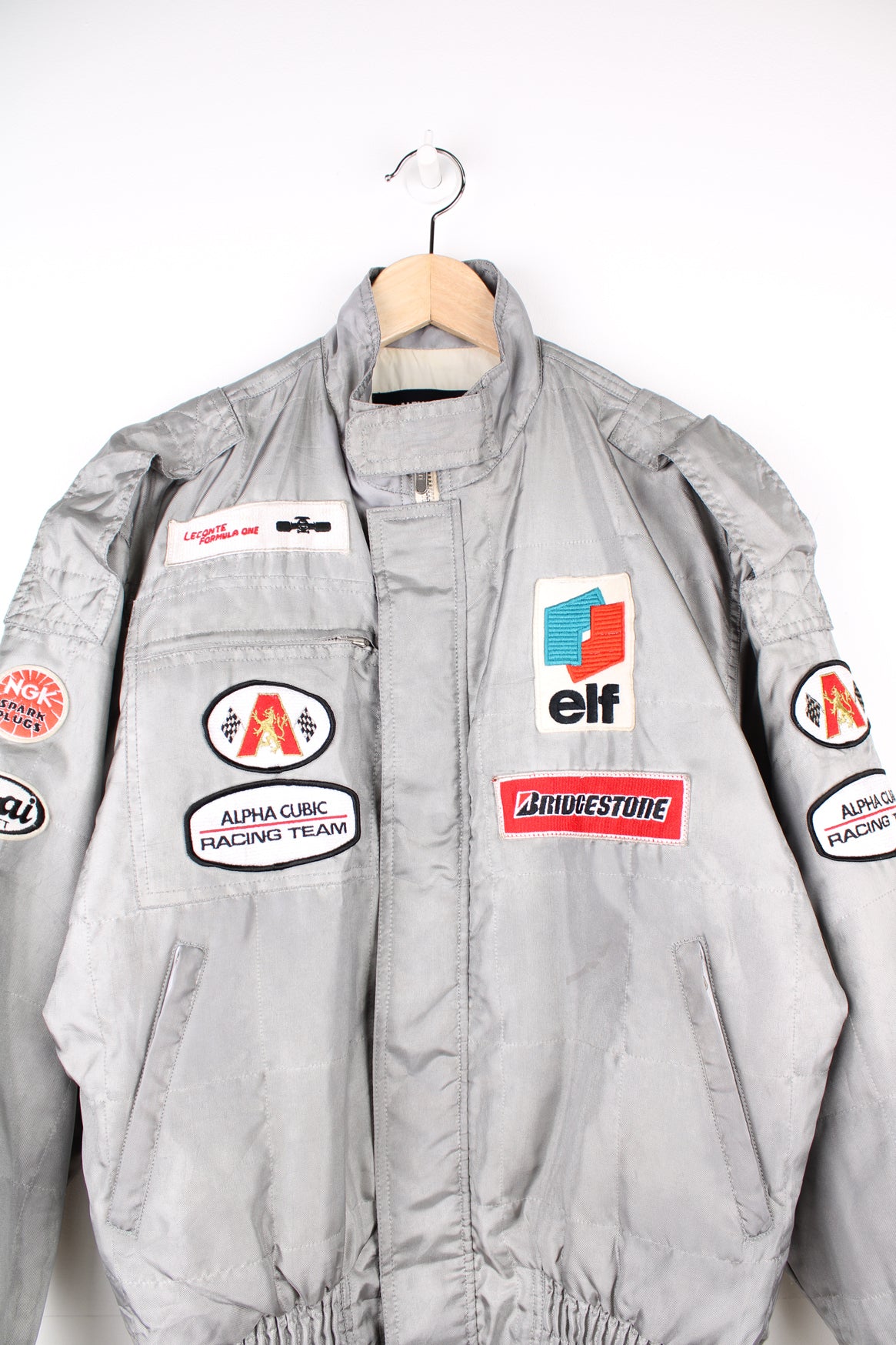 Vintage Alpha Cubic nylon bomber style formula 1 racing jacket in grey, features all over embroidered badges/patches and full zip