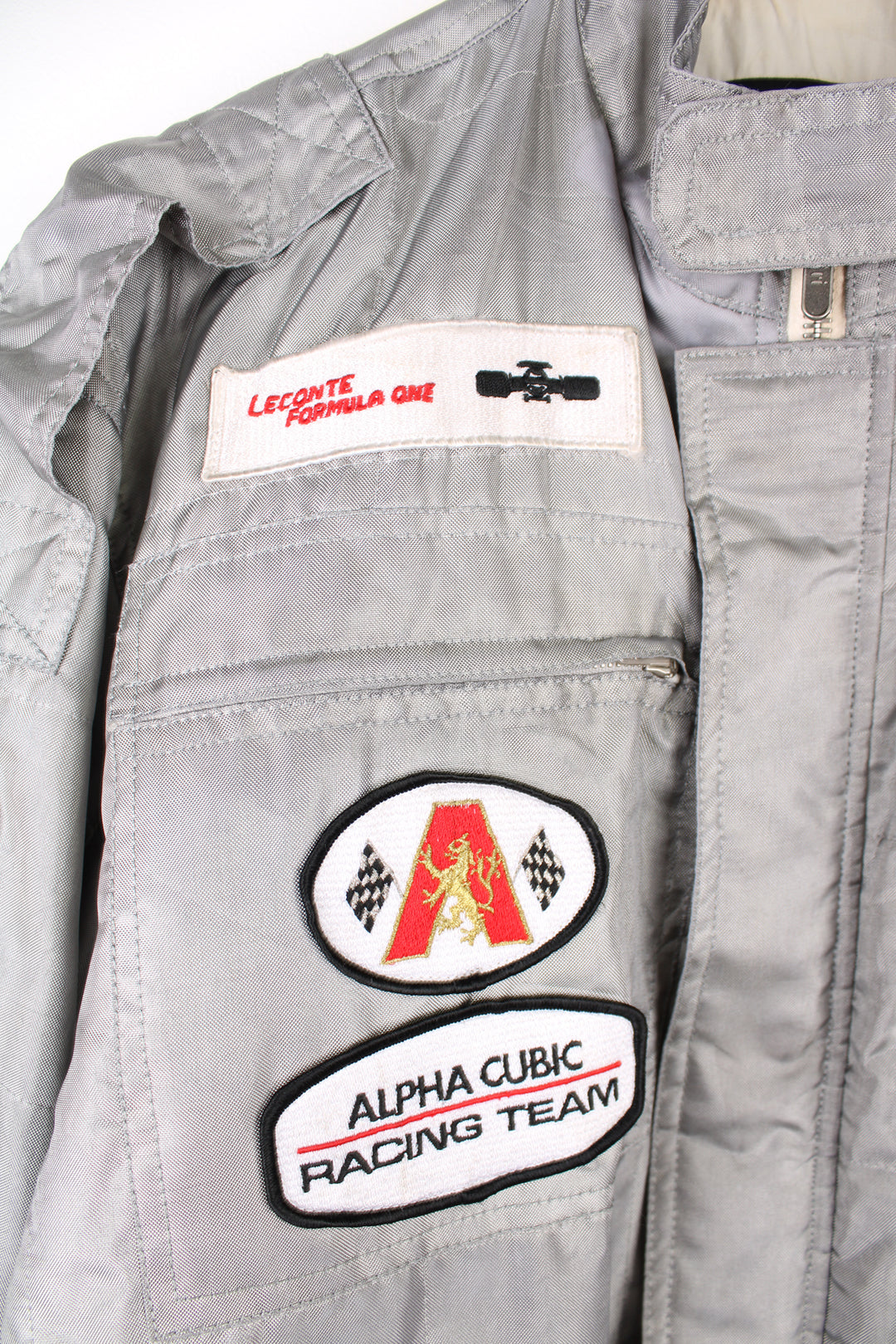 Vintage Alpha Cubic nylon bomber style formula 1 racing jacket in grey, features all over embroidered badges/patches and full zip