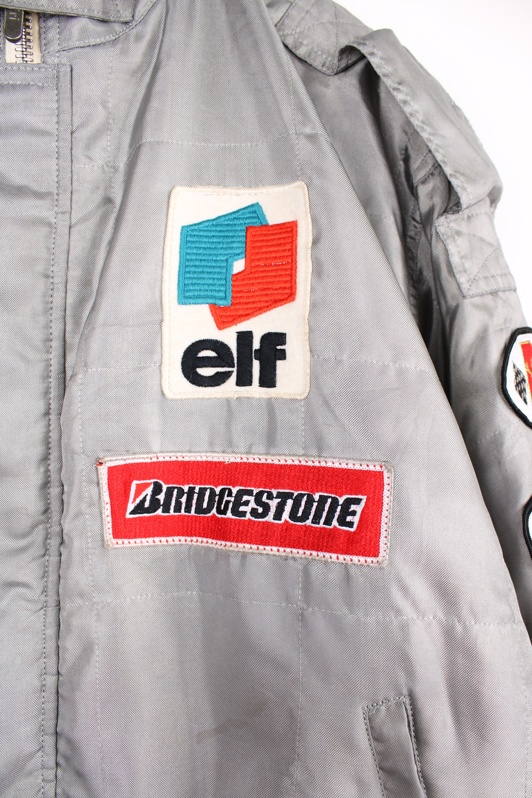 Vintage Alpha Cubic nylon bomber style formula 1 racing jacket in grey, features all over embroidered badges/patches and full zip