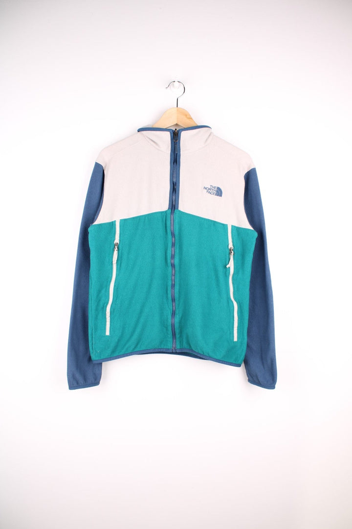 The North Face Glacier Alpine Fleece in a blue and white colourway. Zips up and has side pockets, and the logo is embroidered on the front.