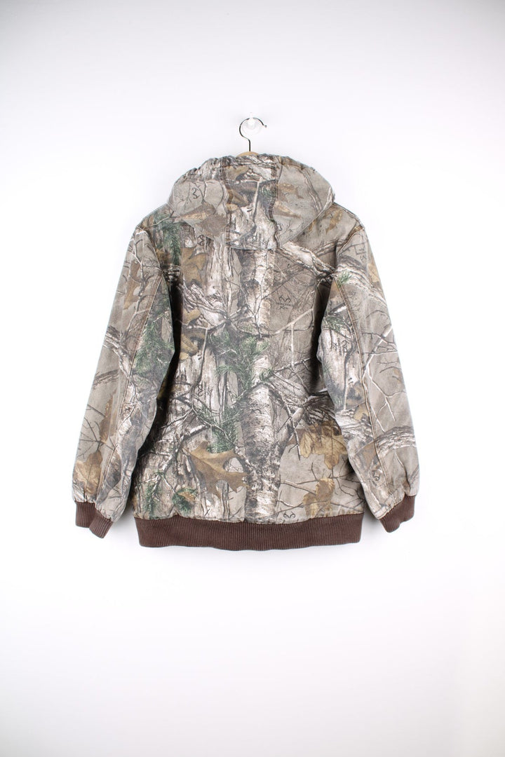  Real Tree Camo Active Jacket in a  and khaki green colourway. Zips up and has side pockets, insulated with a heavy cotton lining, and has the logos embroidered on the front.