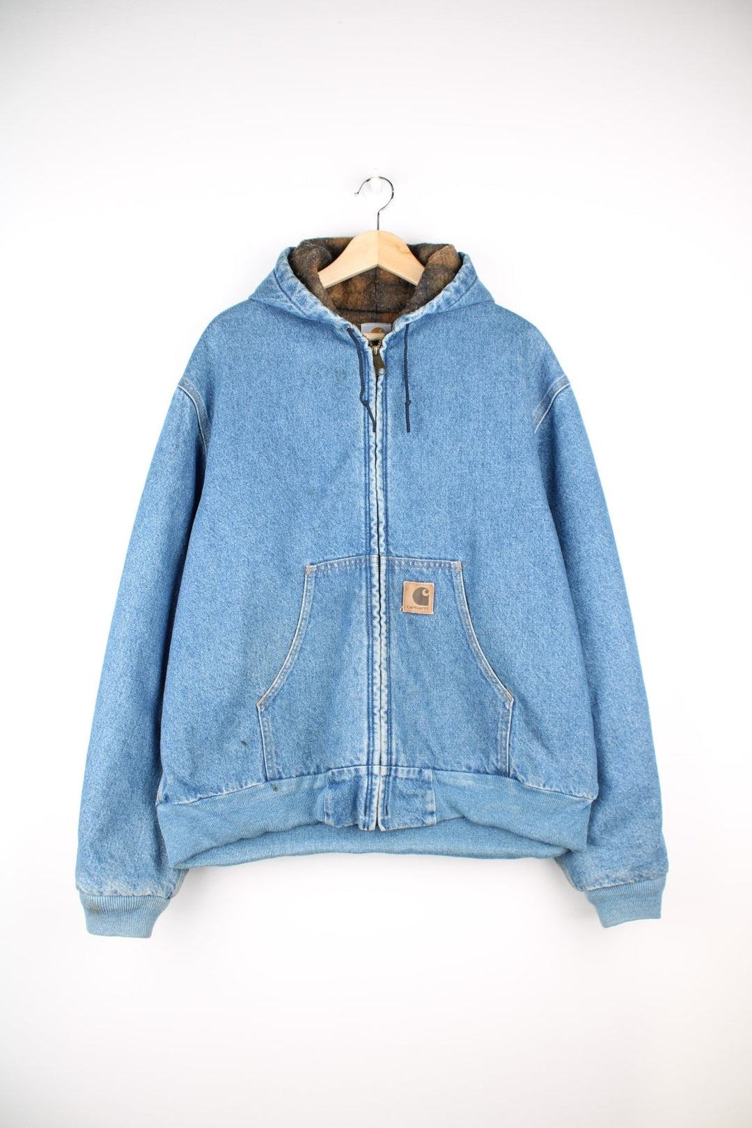 Carhartt Active Jacket in a light blue denim colourway. Zips up and has side pockets, insulated with a blanket lining, hooded and has the logos embroidered on the front.