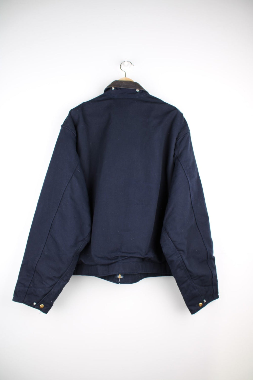  Detroit Jacket in a navy  colourway with a corduroy collar. Zips up and has multiple pockets, insulated with a blanket lining, and has the logos embroidered on the front.