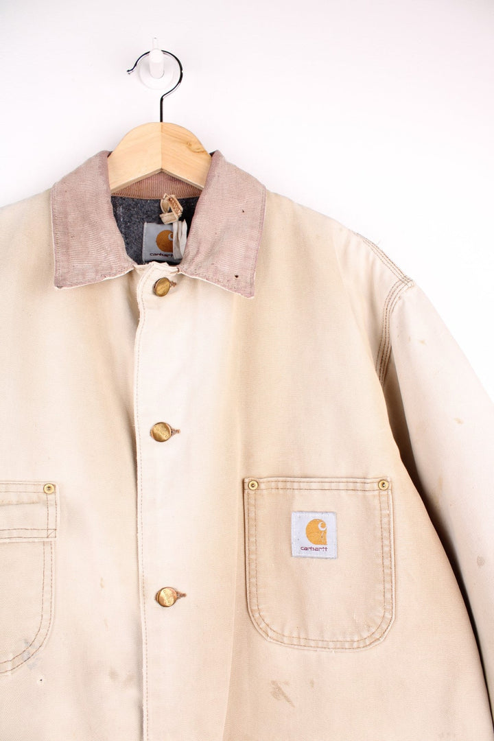  Distressed Chore Jacket in a  colourway. Buttons up and has multiple pockets, insulated with a blanket lining, and has the logos embroidered on the front.