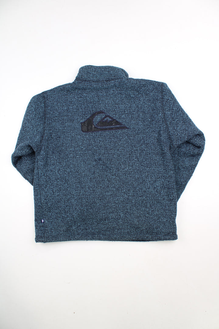 Blue Quiksilver 1/4 zip knit jumper with embroidered logo on the chest and back. good condition - some light bobbling in places Size in Label: Mens M - Measures oversized, more like a L/ XL 