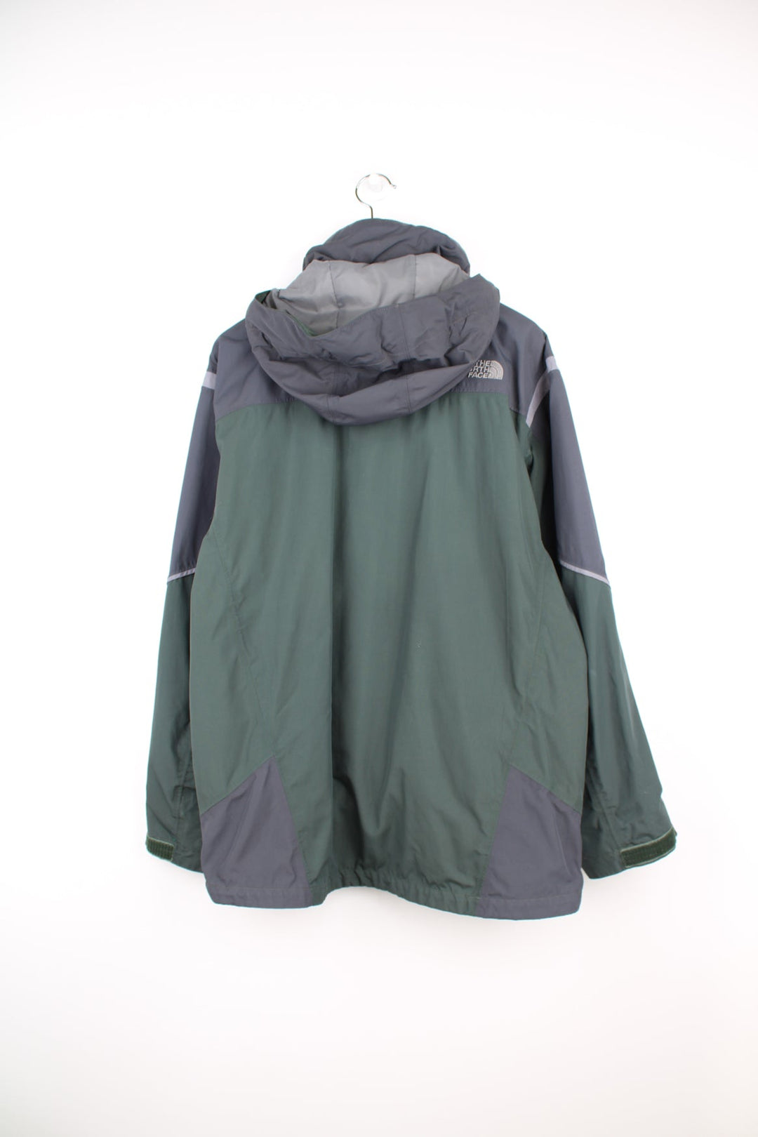 Green and grey The North Face ski jacket. Features embroidered logo on the chest, removable hood, chest and sleeve pockets, inside pockets and snow skirt.