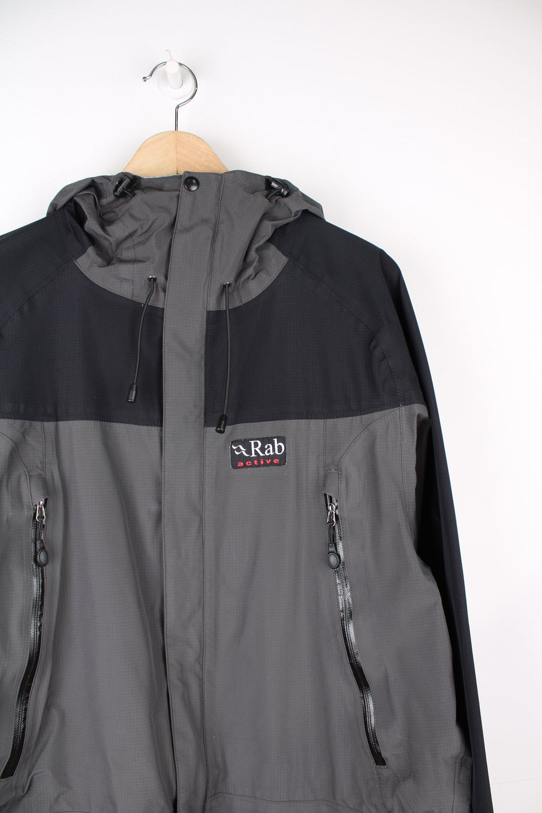 Rab Active zip through rain jacket in black and grey featuring embroidered logo on the chest. 