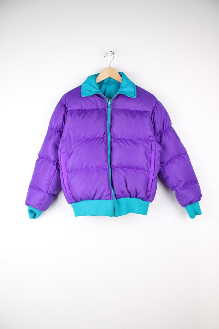 Vintage Columbia reversible puffer jacket in purple and green. Features puff print logo on the chest.