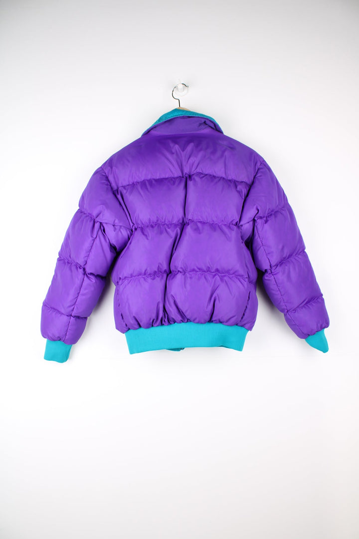 Vintage Columbia reversible puffer jacket in purple and green. Features puff print logo on the chest.