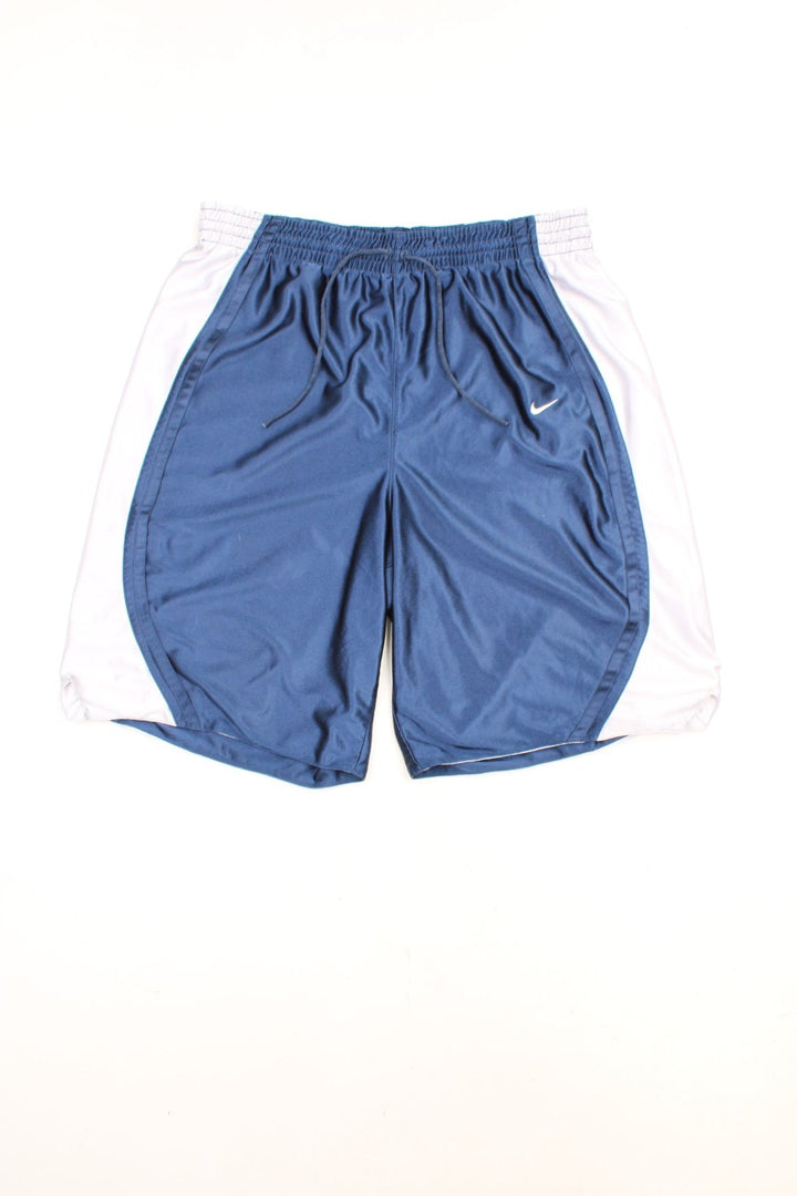 Nike Basketball Shorts in a blue and silver colourway, has an elasticated waist with drawstring, no pockets, and has the swoosh logo embroidered on the front. 