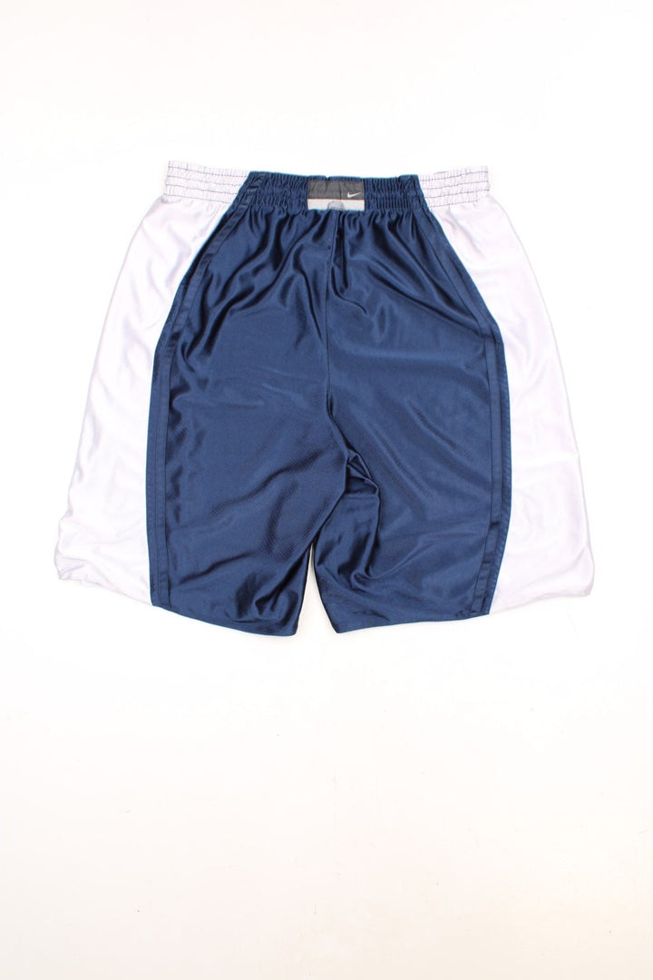 Nike Basketball Shorts in a blue and silver colourway, has an elasticated waist with drawstring, no pockets, and has the swoosh logo embroidered on the front. 