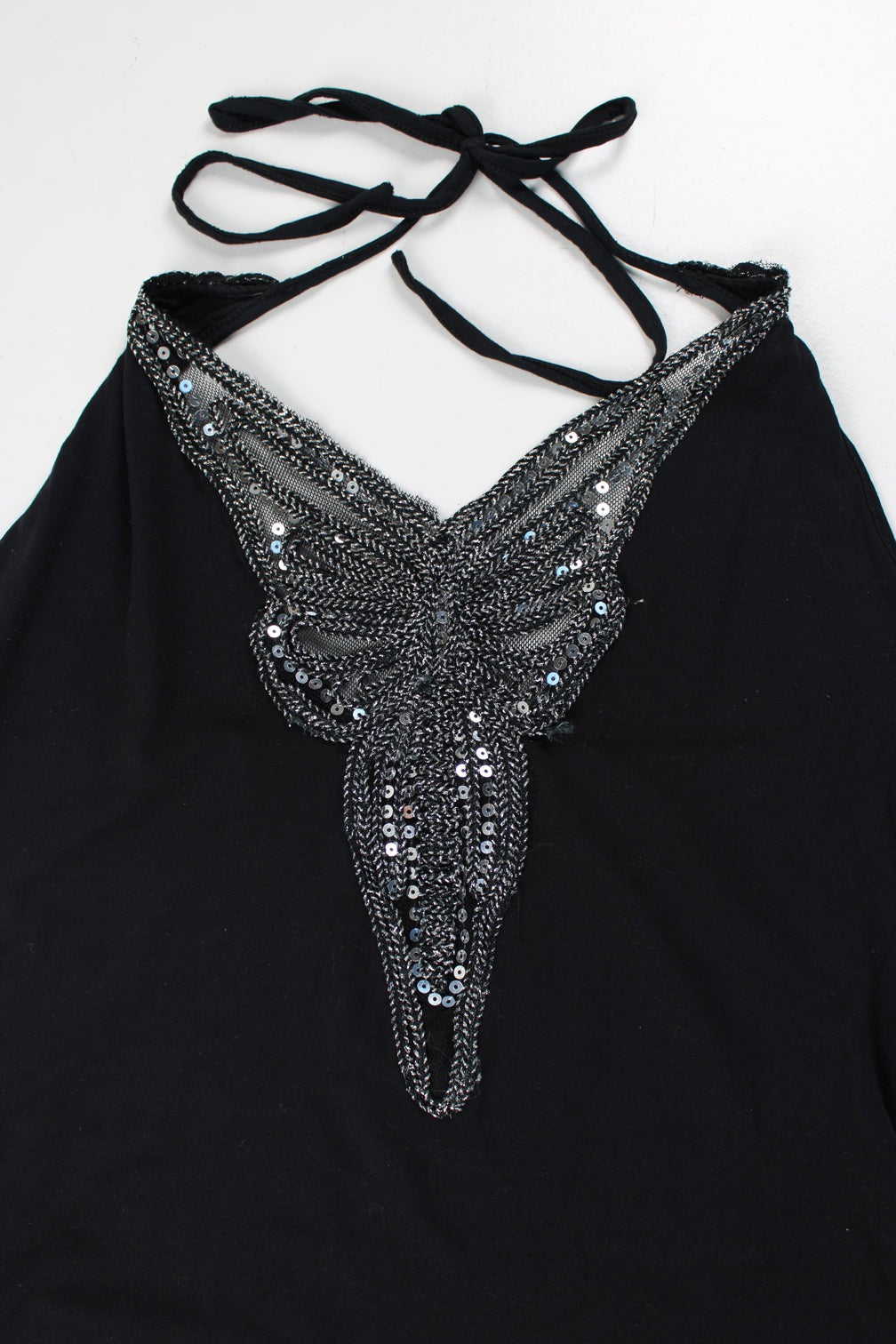 Black Y2K Morgan tie halter neck top, features metallic silver embroidered butterfly on the front