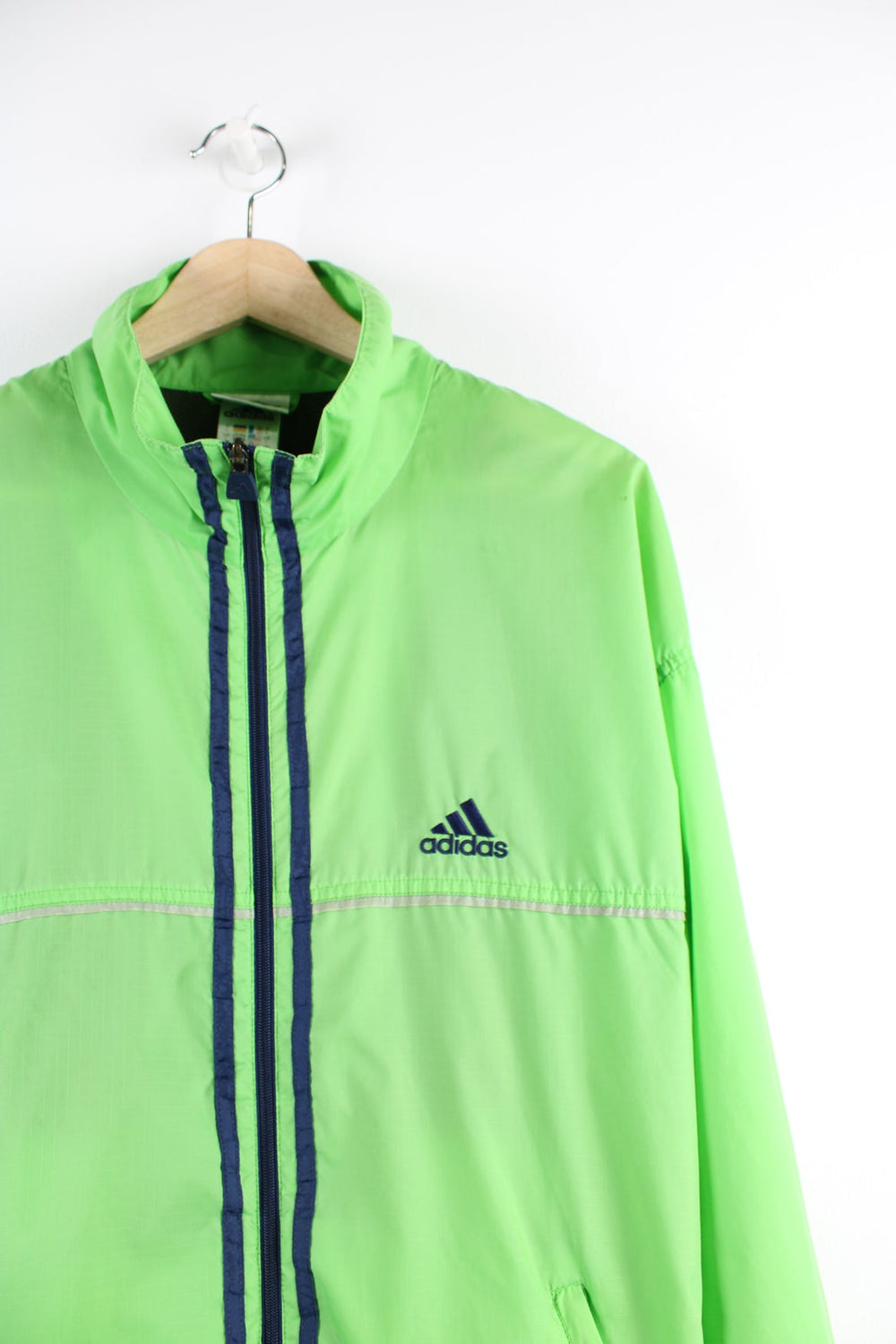 Vintage green tracksuit jacket with embroidered logo on the chest and blue three stripe feature down the front and sides