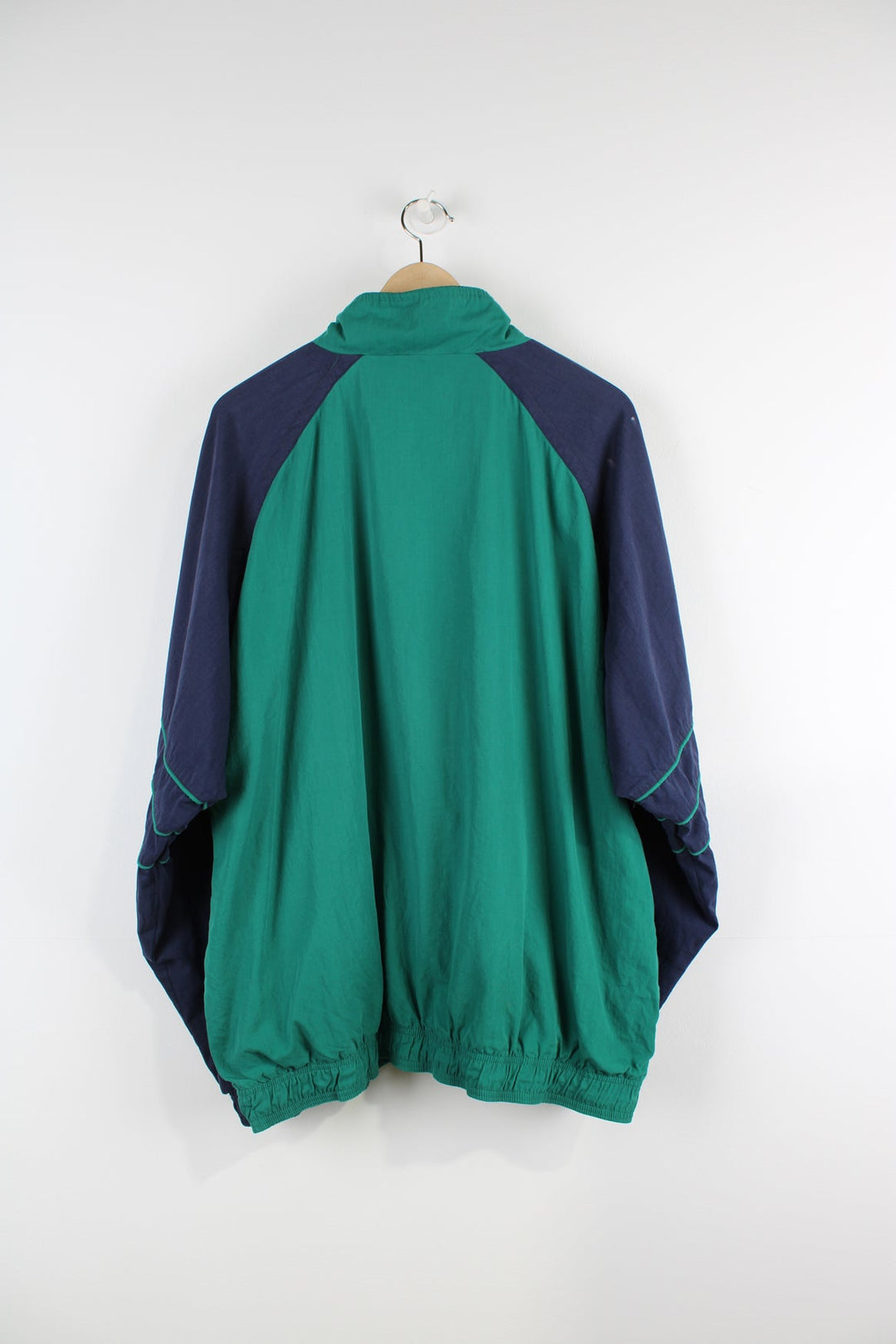 Vintage green and blue Adidas tracksuit jacket with embroidered logo on the chest