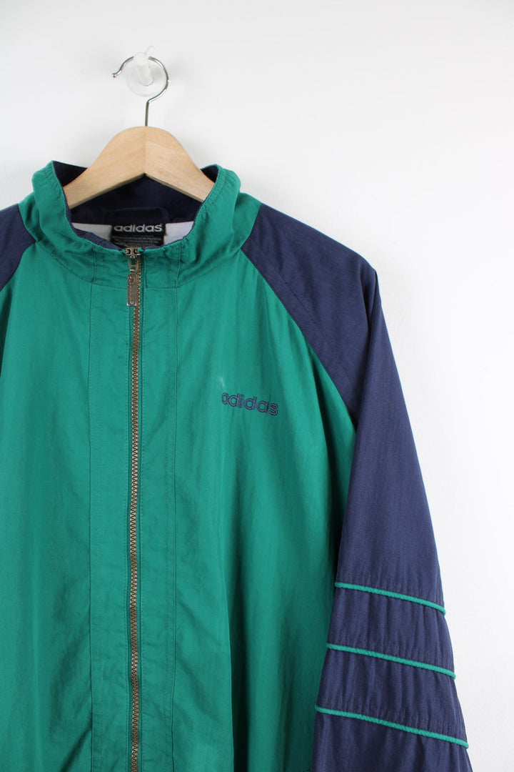 Vintage green and blue Adidas tracksuit jacket with embroidered logo on the chest