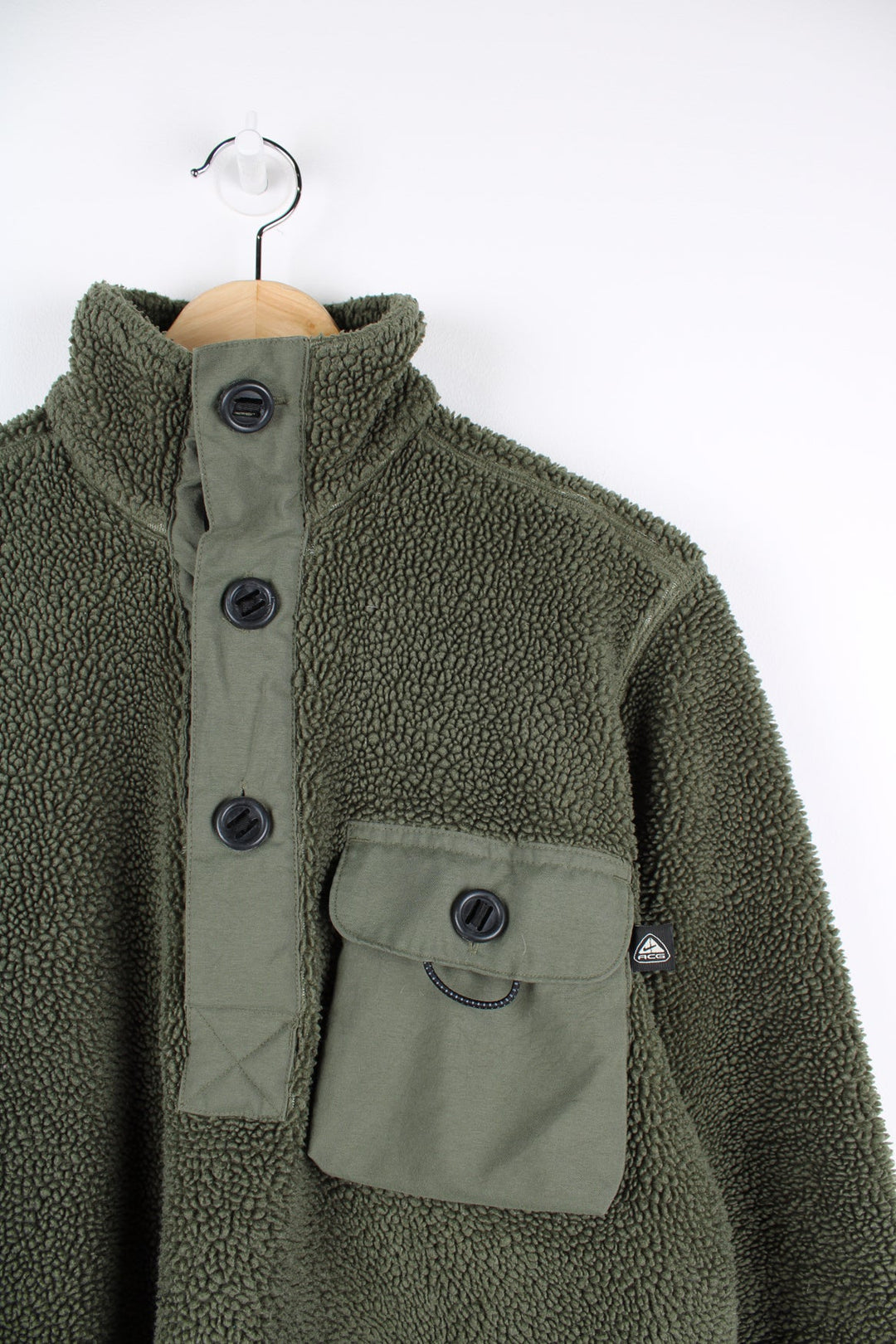 Green Nike ACG teddy style fleece with pocket on the chest.