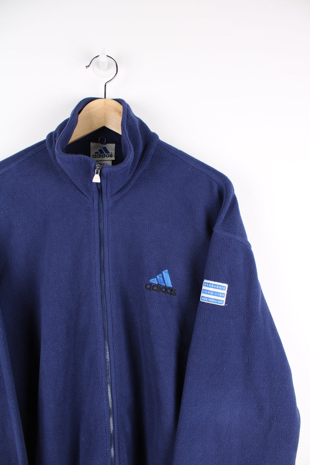 Blue zip through Adidas fleece with embroidered logo on the chest and arm.