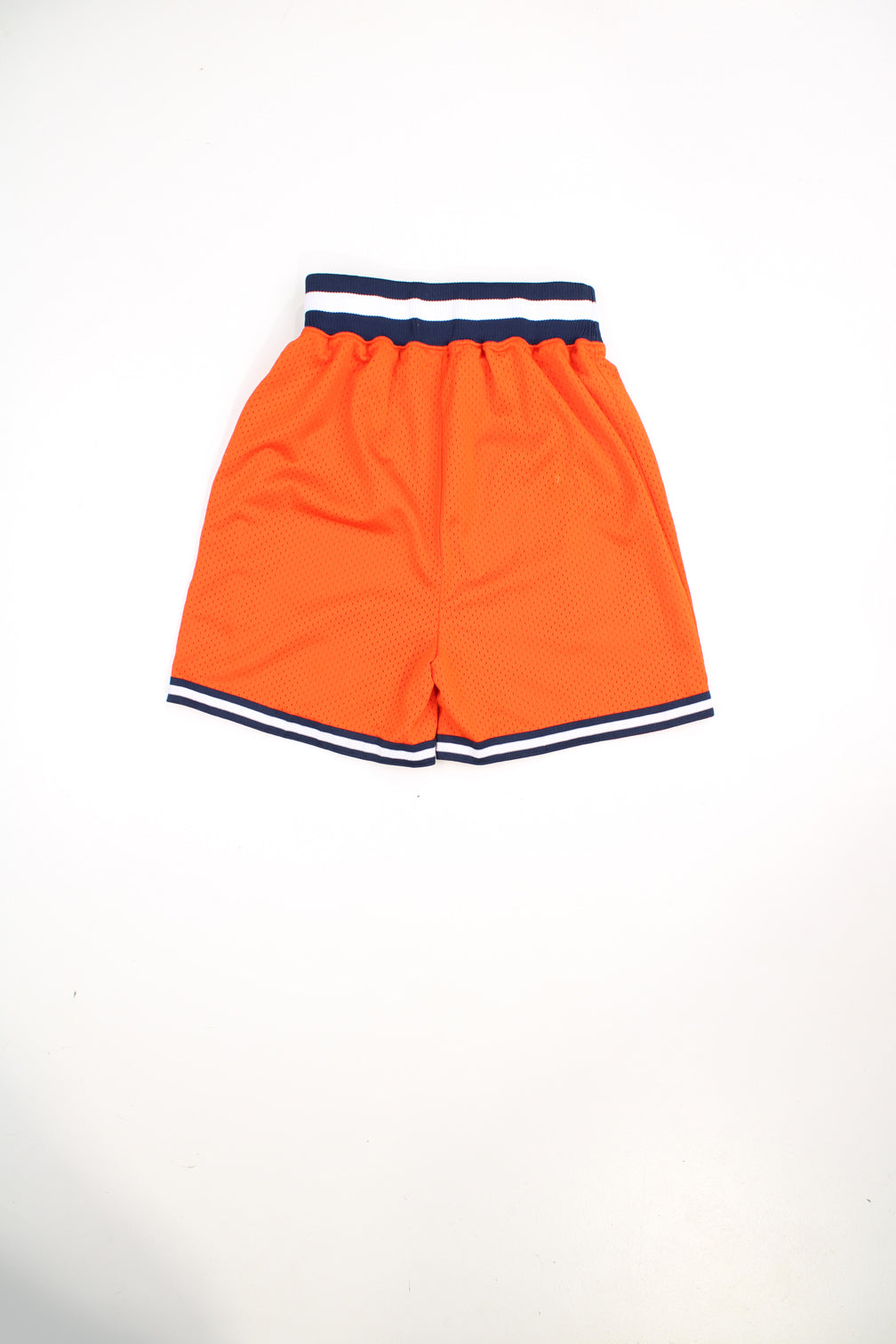 Vintage Nike New York Knicks NBA basketball shorts in orange. Features embroidered logo and drawstring waist.