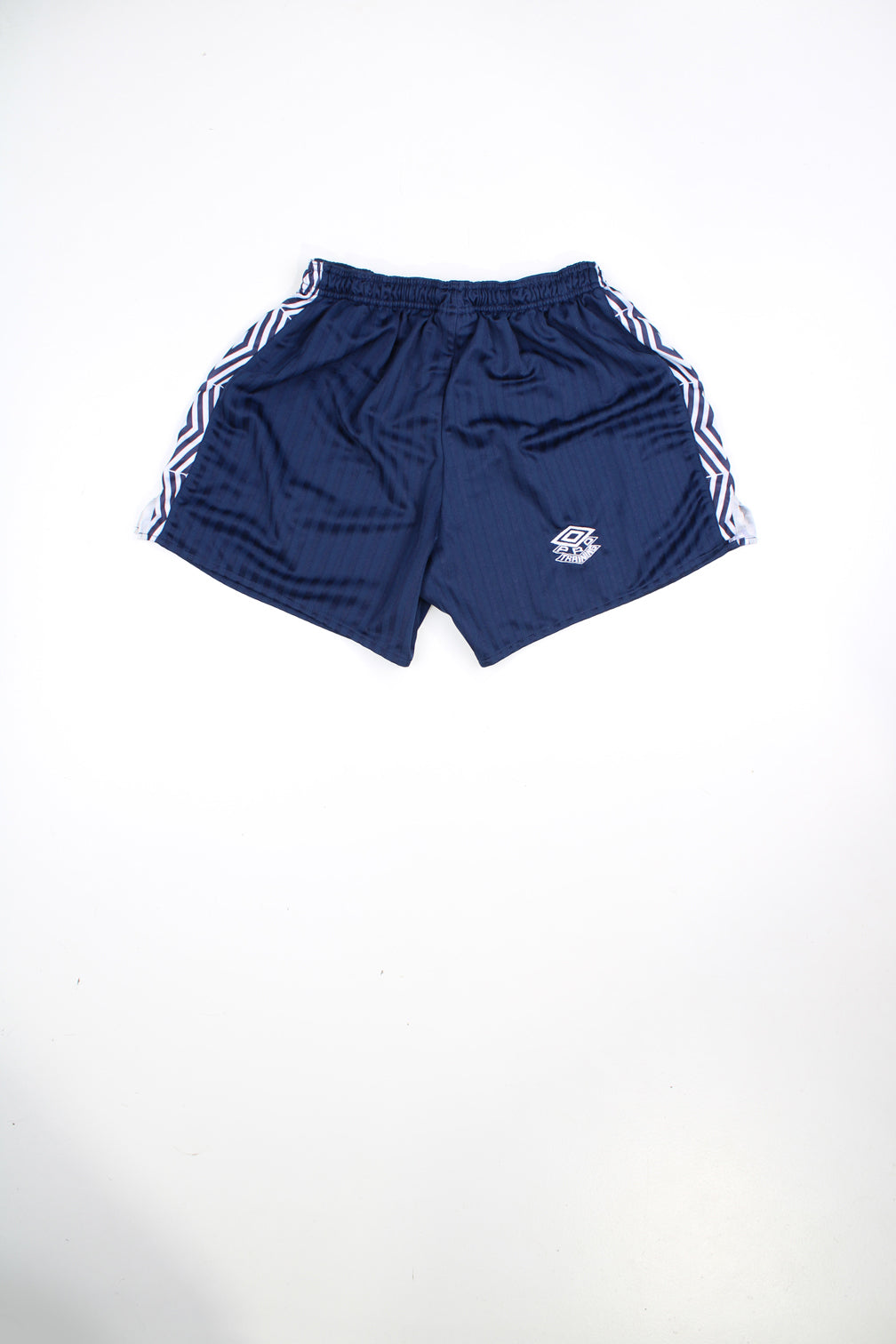 Vintage Umbro 90s blue football shorts with elasticated waist and drawstring. Features embroidered logo.