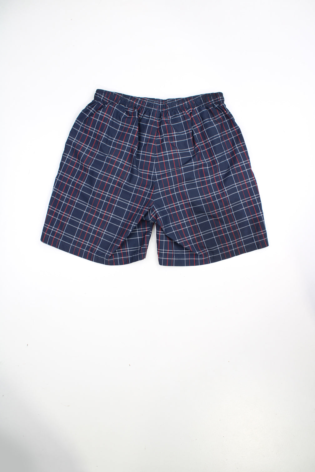 Blue Reebok swim shorts with red and white checks. Features elasticated waist, drawstring and embroidered logo. 