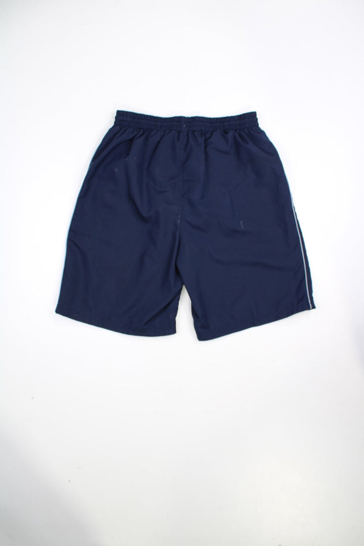 Vintage blue Umbro swim shorts with elasticated waist and drawstring. Features embroidered logo.