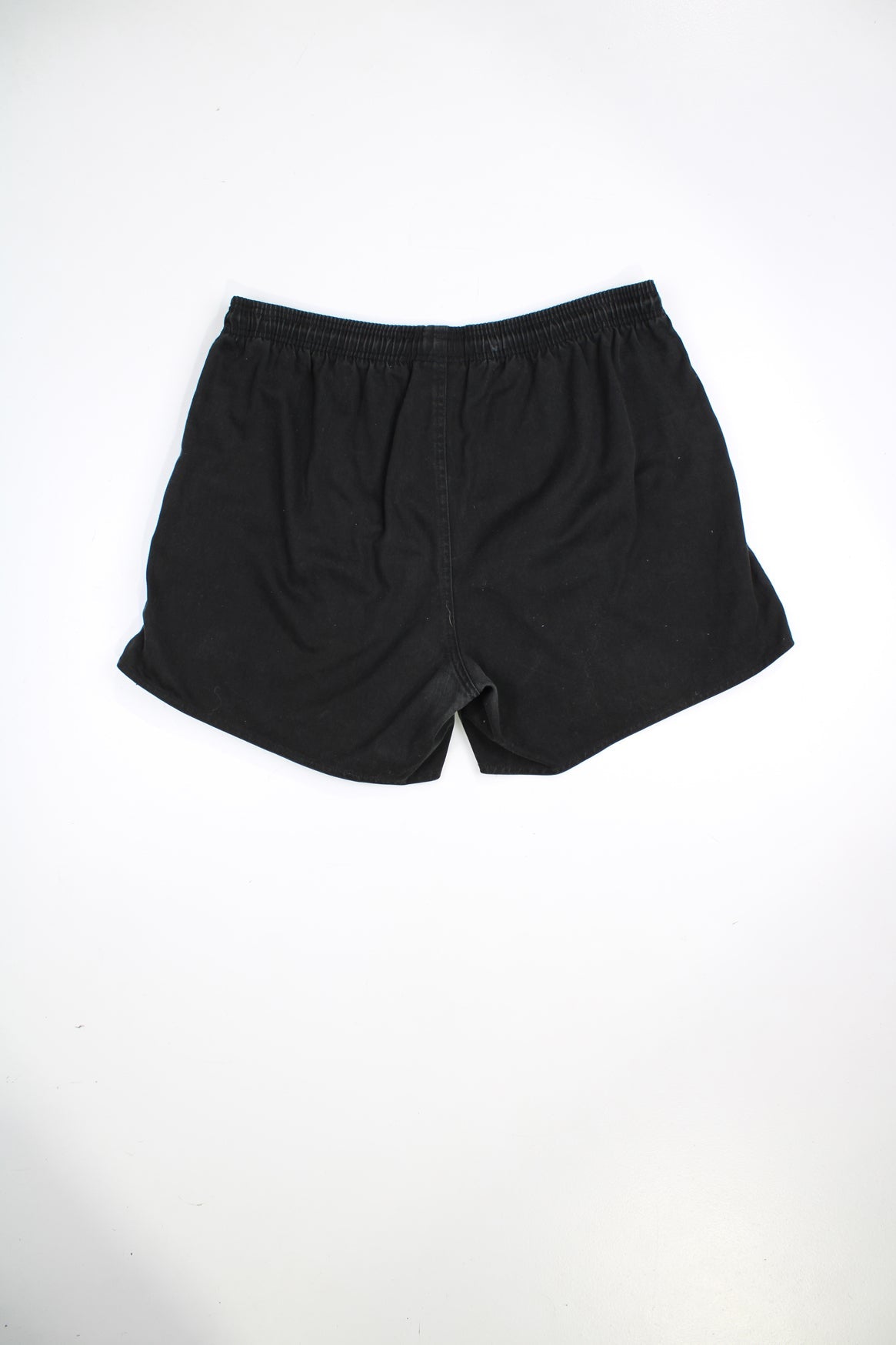 Black Adidas vintage shorts with elasticated waist and drawstring. Features signature three stripes and embroidered logo.