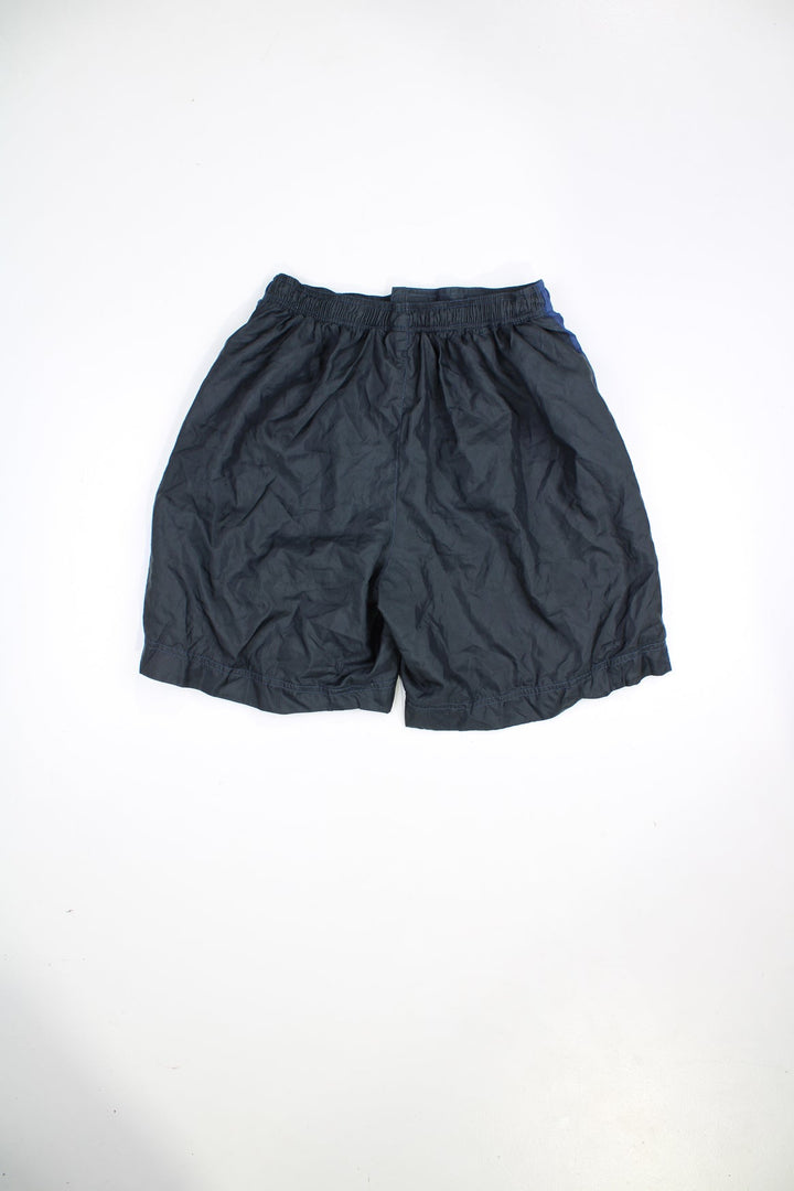 Vintage 90s Adidas shorts with velcro fastening. Features embroidered logo and blue stripe detail.