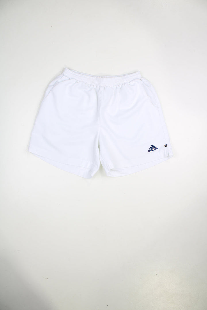 Vintage Adidas shorts with elasticated waist and drawstring. Features embroidered logo on the front and back.