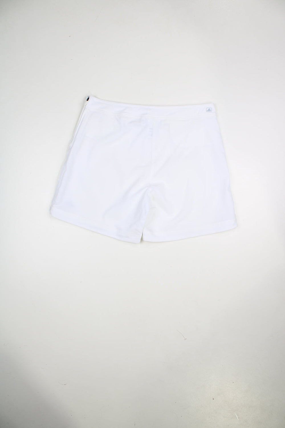 Vintage Adidas white shorts with embroidered logo and zip fastening.