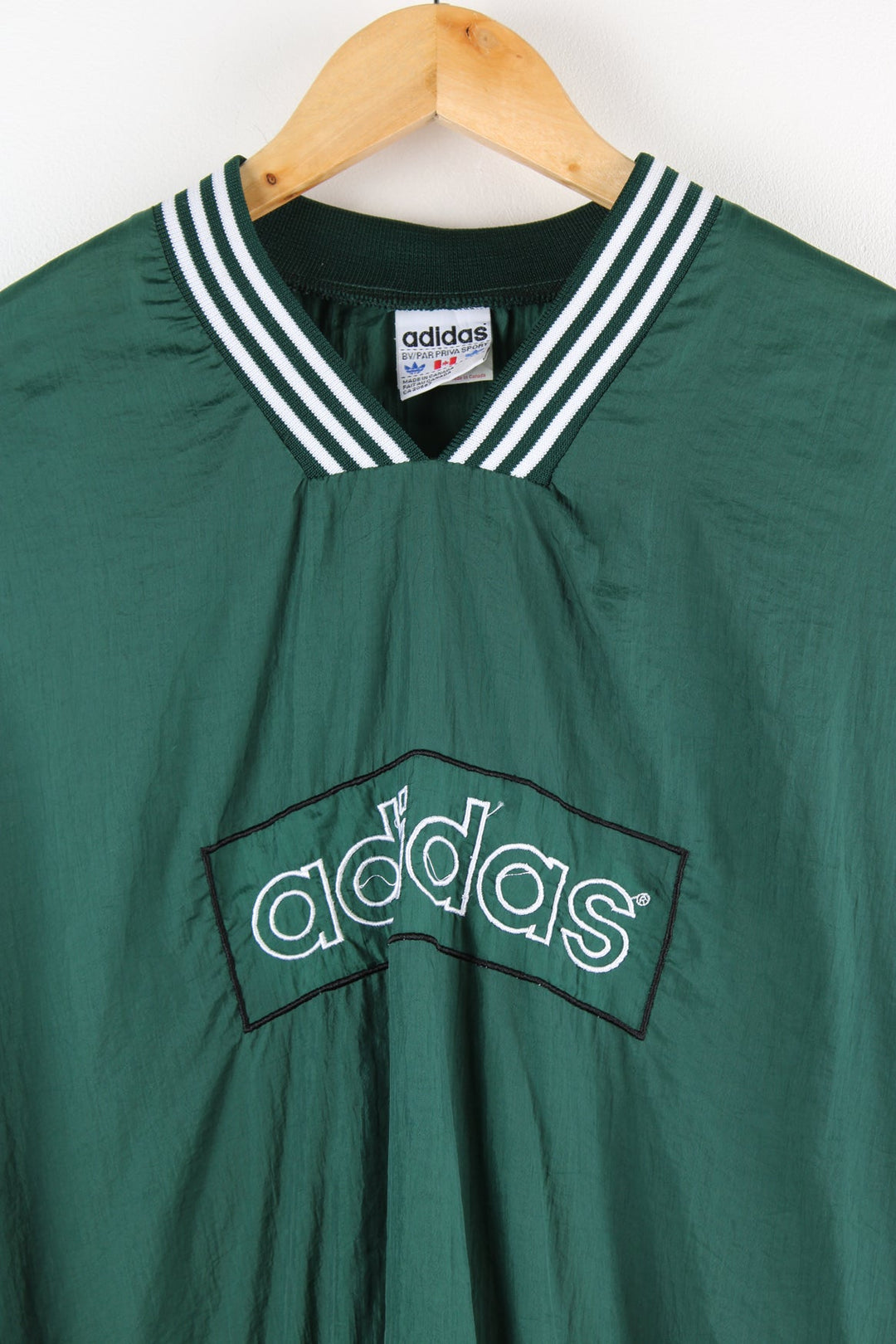 Vintage Adidas drill top in green. Features embroidered spell out logo across the chest.