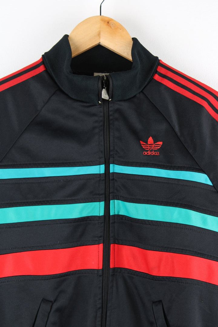 Vintage 80s Adidas tracksuit top in black with red and green stripes. Features embroidered logo on the chest.