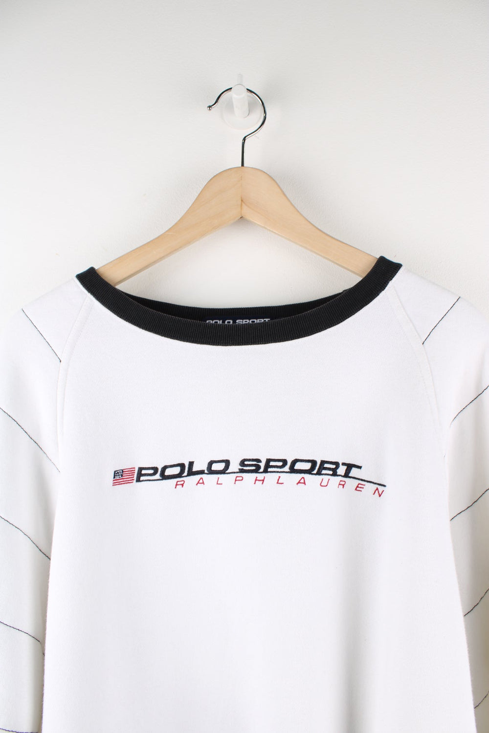 Polo Sport Ralph Lauren white sweatshirt. Features embroidered logo across the chest and blue stitch detail on the sleeves.