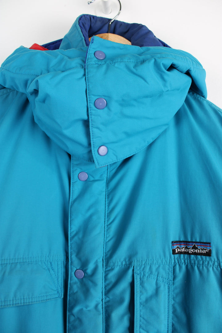 Vintage 90's Patagonia bright blue padded guide coat, features embroidered logo on the chest, mulitple pockets and removable hood