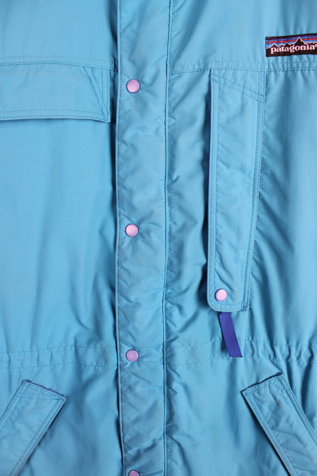 Vintage 90's Patagonia bright blue padded guide coat, features embroidered logo on the chest, mulitple pockets and removable hood