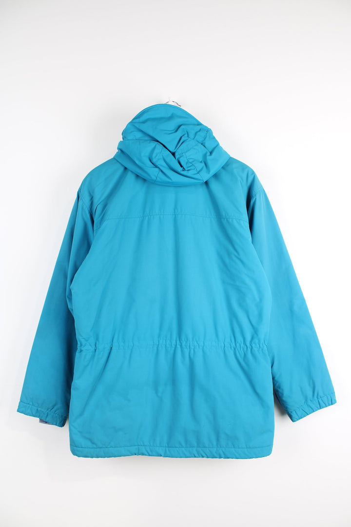 Vintage 90's Patagonia bright blue padded guide coat, features embroidered logo on the chest, mulitple pockets and removable hood