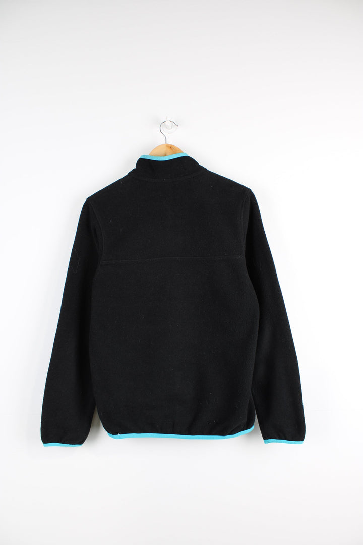 Patagonia Synchilla fleece in black features snap t closure and embroidered logo on the chest