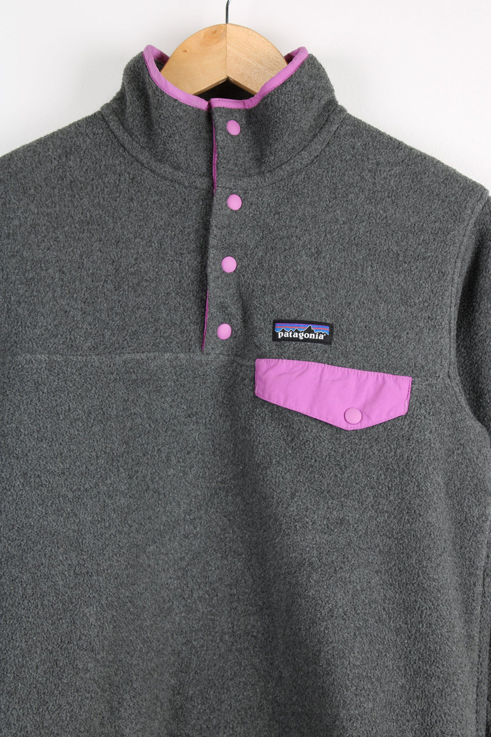 Patagonia Synchilla fleece in grey features snap t closure and embroidered logo on the chest 