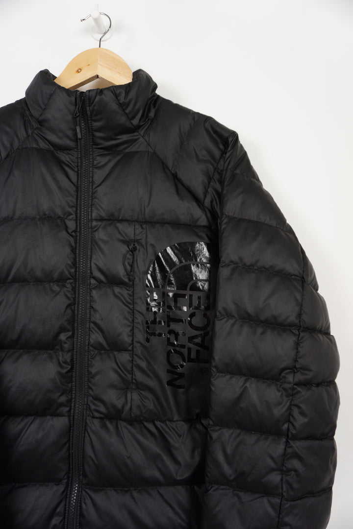 All black The North Face shine logo puffer jacket with double pockets and drawstring hem